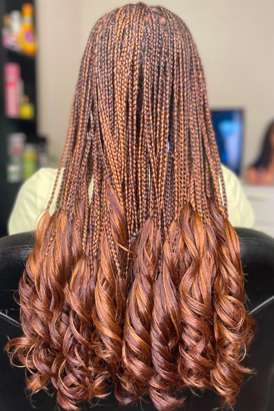 Auburn braids finishing in large loose curls