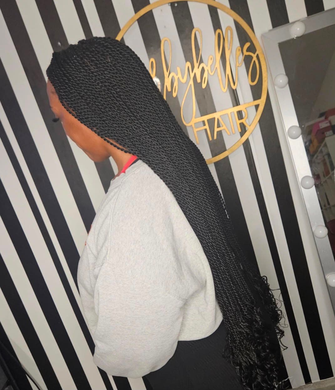 Black Senegalese rope twists swept into a long ponytail